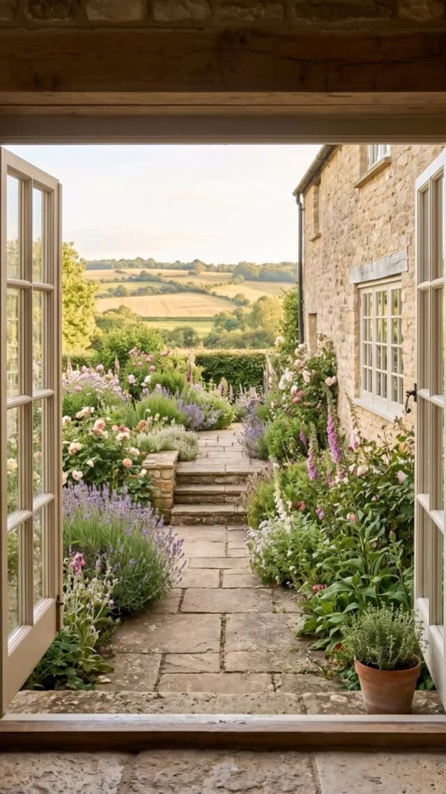 13 Cottage Garden Front Yard Ideas for Curved Paths to Climbing Roses 8 Stone pathway winding through a lush cottage garden filled with colorful flowers and purple lavender plants.