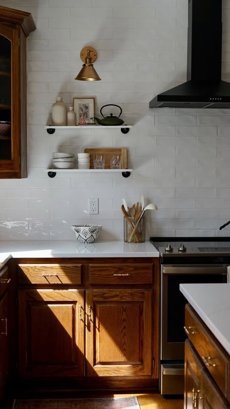 12 DIY Kitchen Makeover Ideas for Cabinets, Islands and Lighting 10 Wooden kitchen cabinets featuring gold metal knobs and pulls against a white tiled wall.